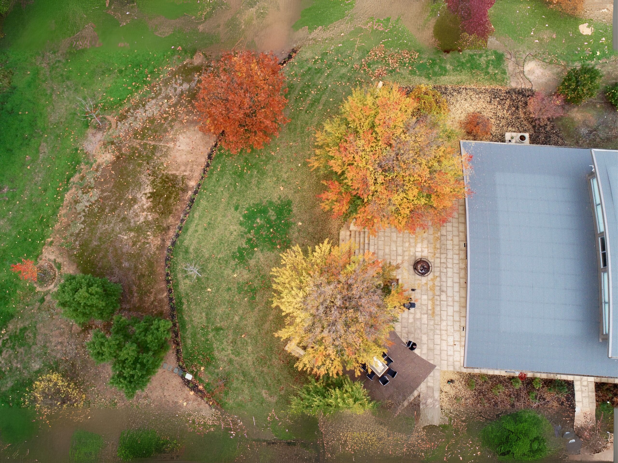 Aerial view of Monteperle winery cellar door surrounded by autumn vineyard landscape